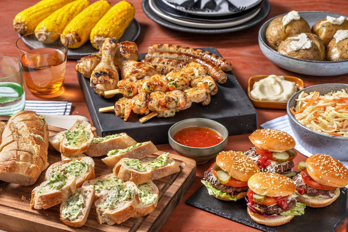 BBQ met garnalenspies, hamburger, kipdrumsticks en een boerenworst