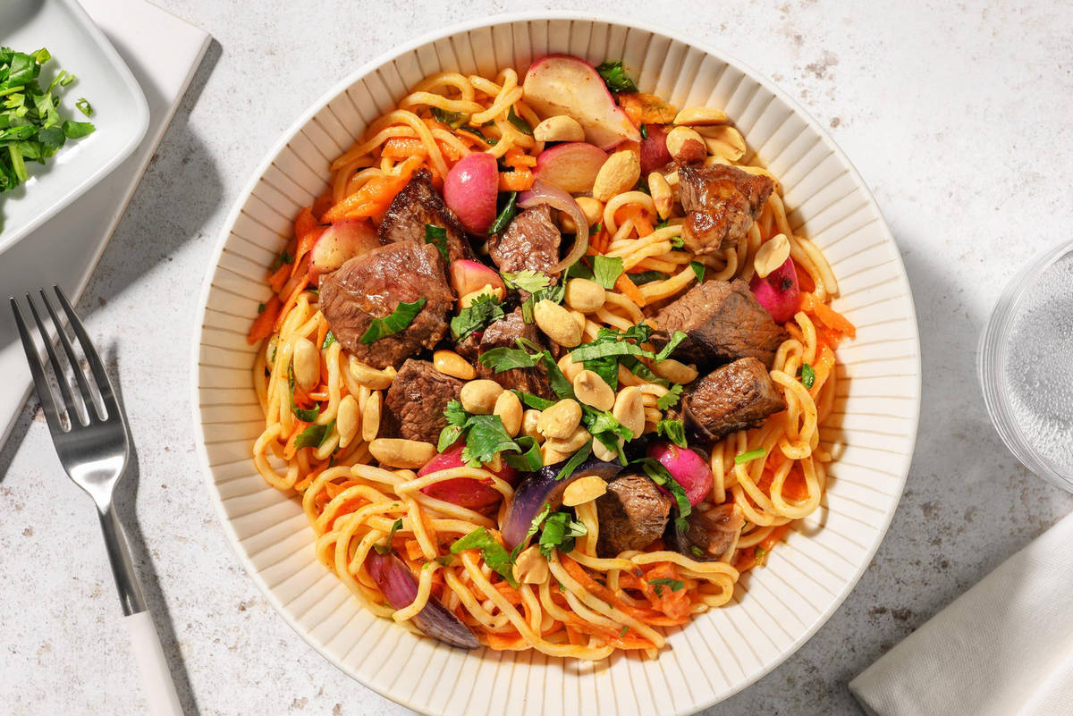 Noedelsalade met biefstukreepjes, pinda's en verse kruiden