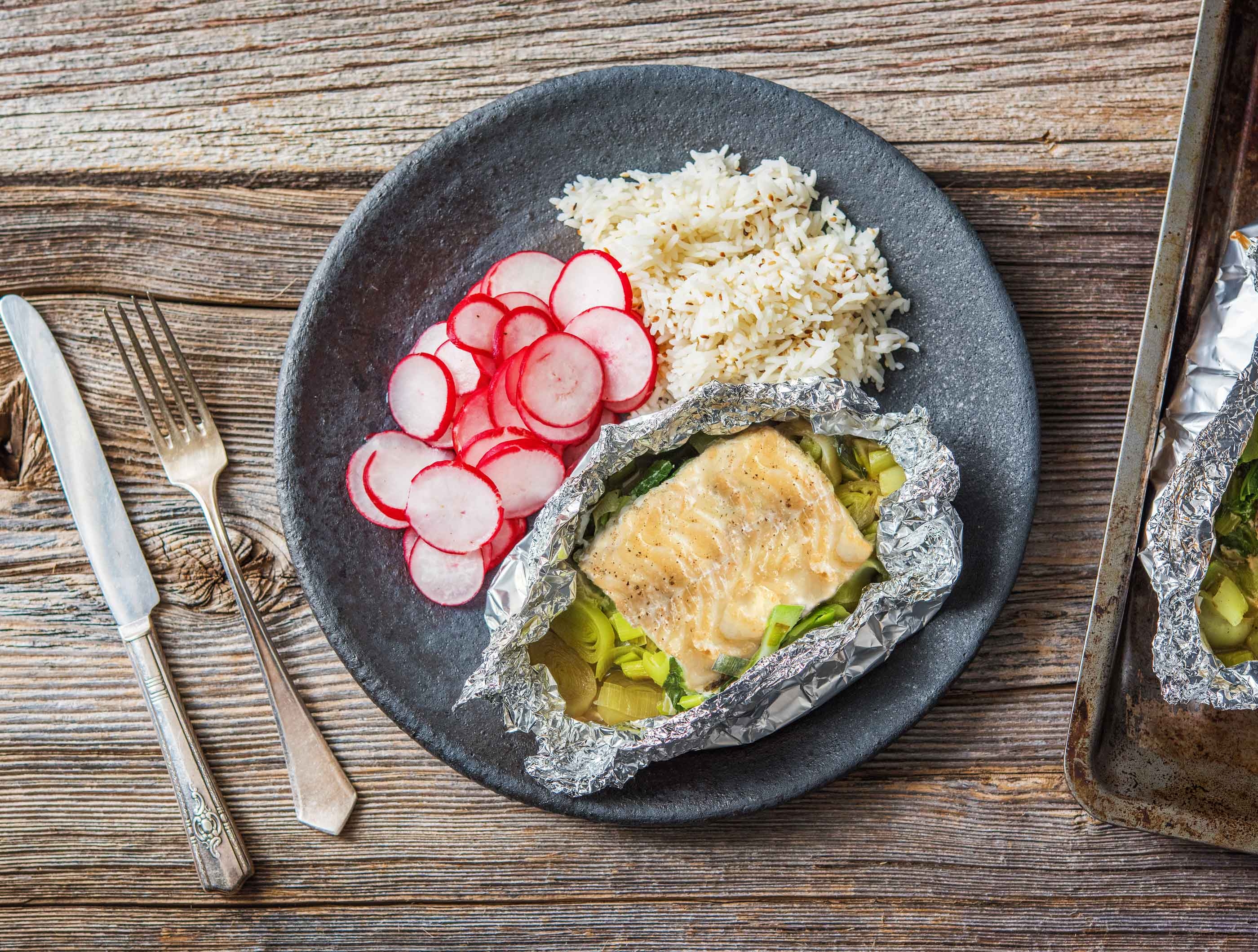 Papillote de poisson aux légumes orientaux servie avec du riz