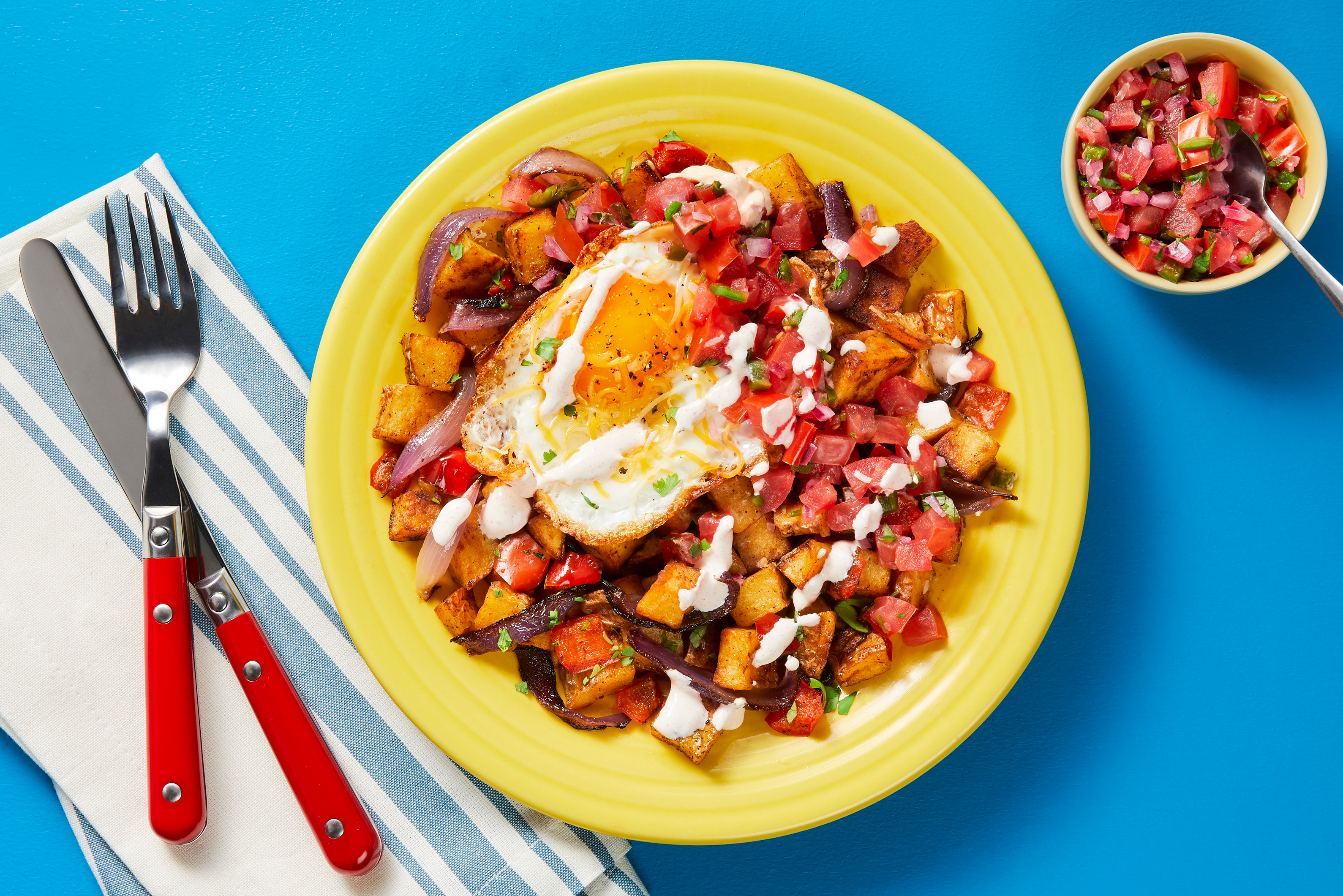 Steak & Cheesy Eggs over Nacho Hash