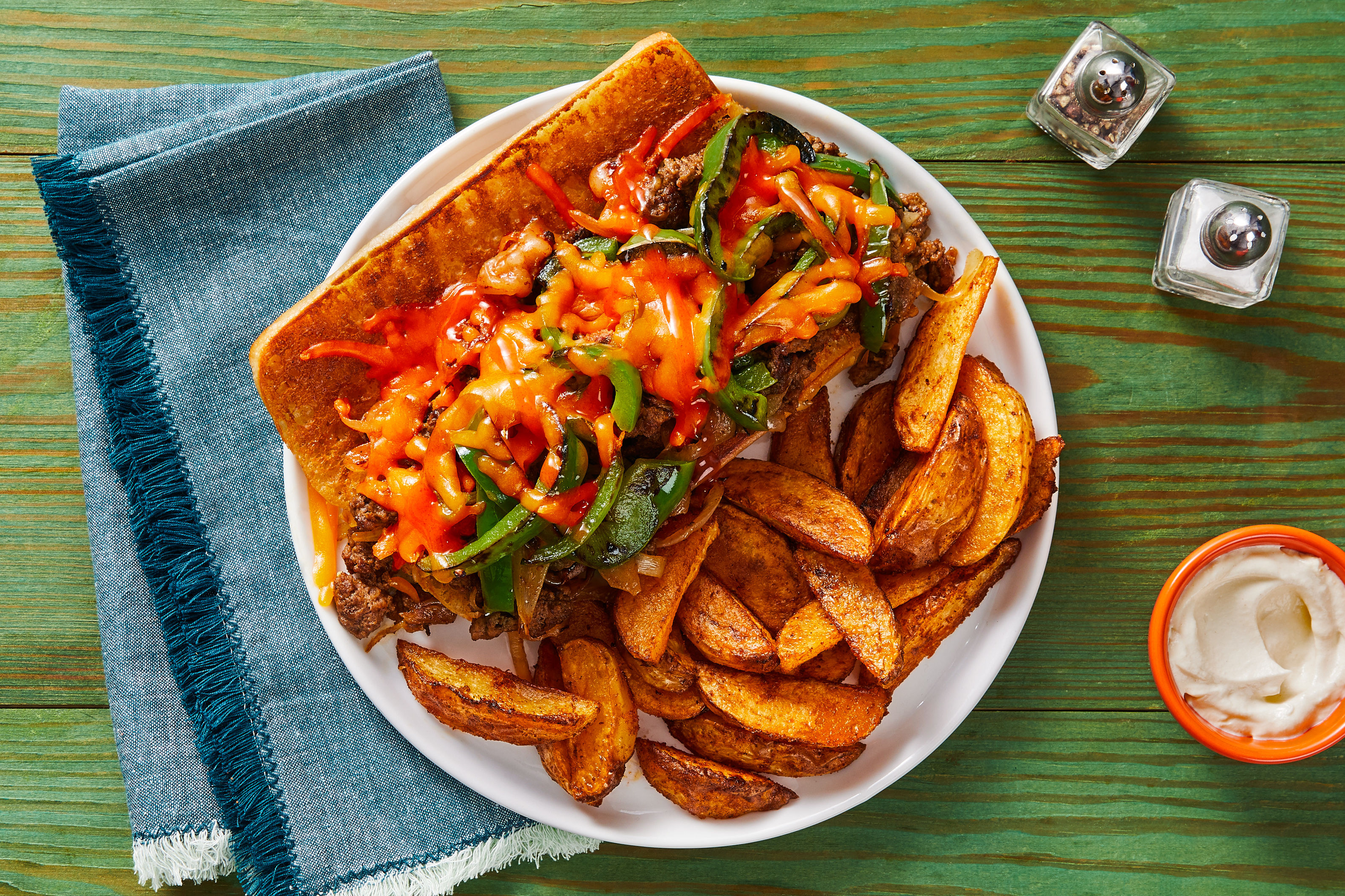 Philly-Style Beef Melts with Potato Wedges