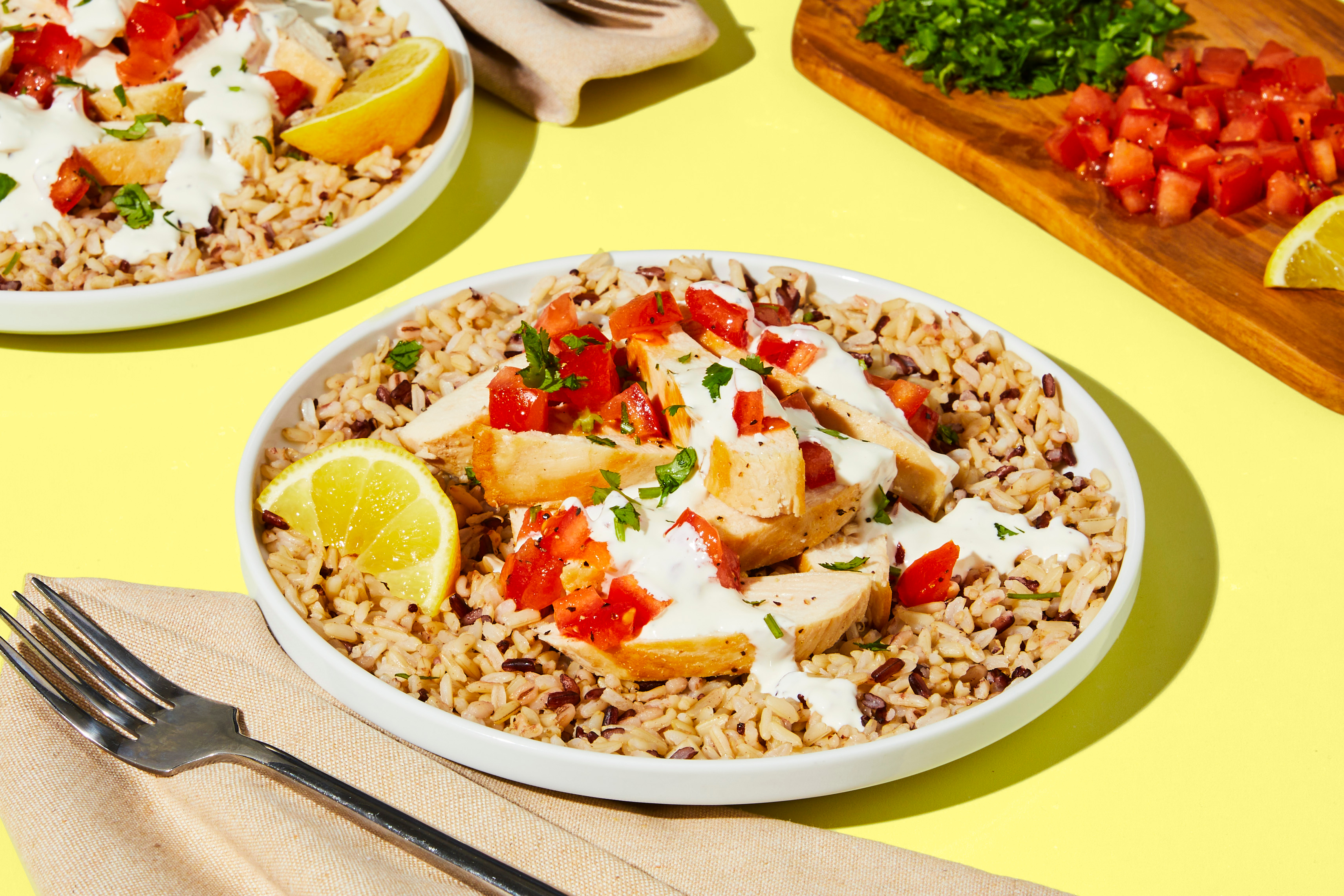 10MM Chicken with Creamy Garlic Sauce and Marinated Tomatoes over Mixed Grains