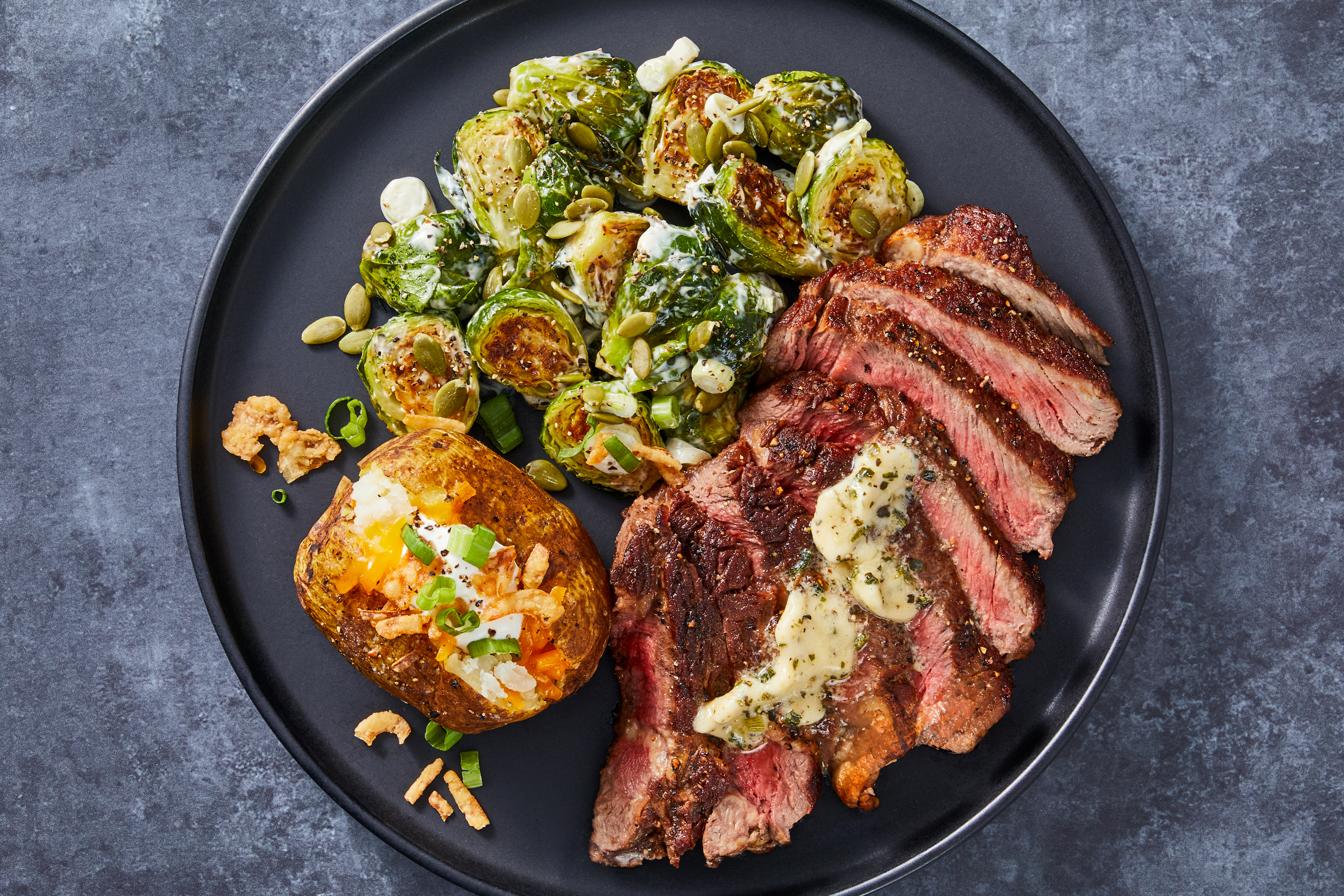 Garlic Herb Rib-Eye & Loaded Baked Potatoes