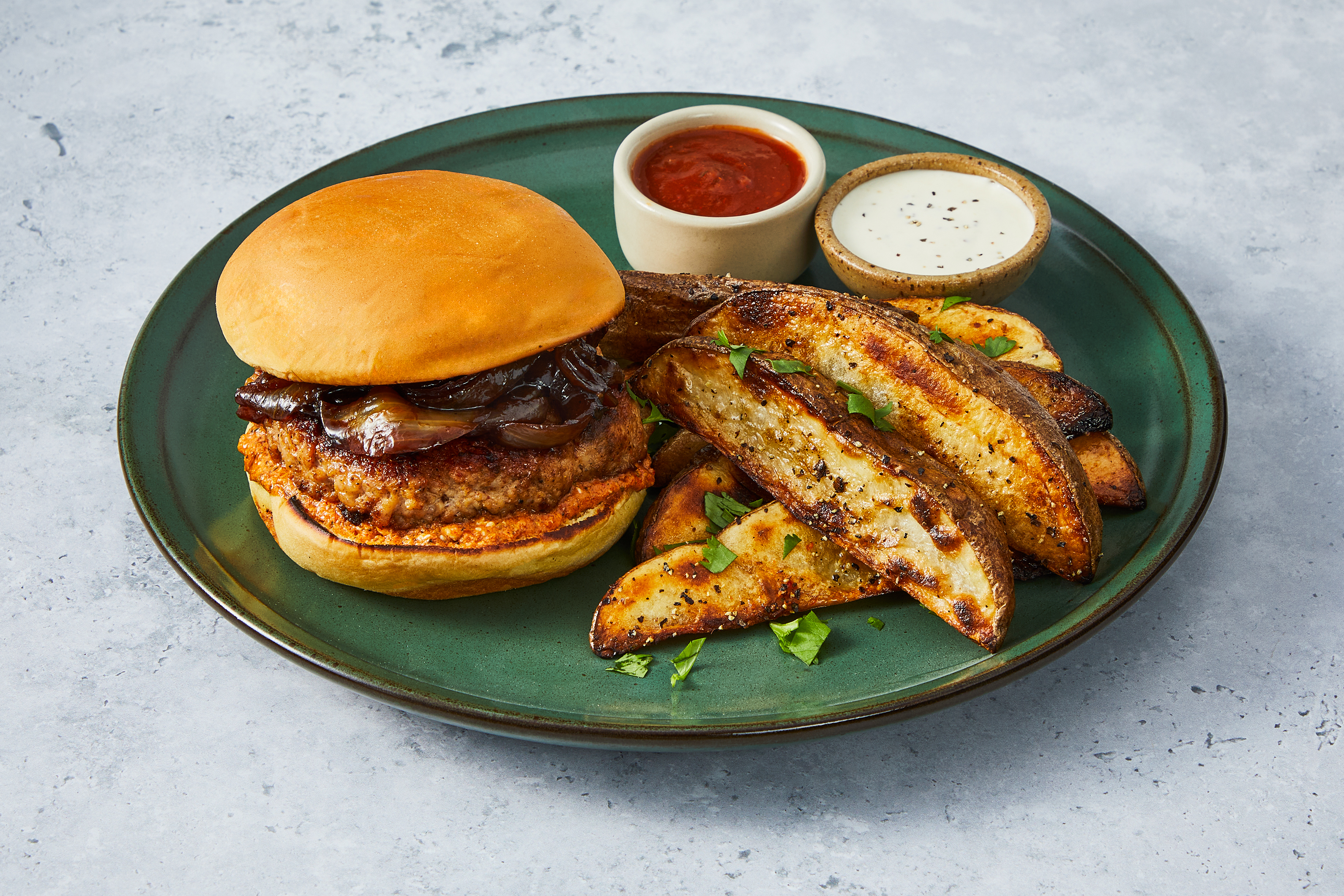 [UPGRADE GROUND TURKEY TO ADD BACON] Spanish-Style Turkey Burger Topped with Caramelized Onions and Romesco Cheese Spread served with Potato Bravas Wedge Fries