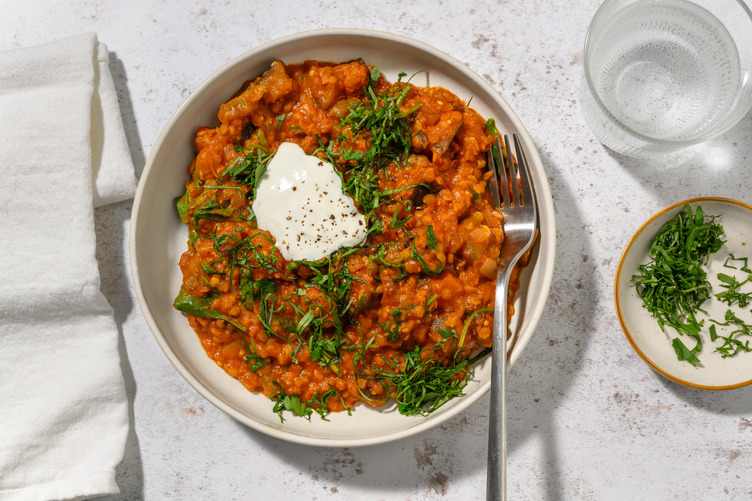 Dal de berenjena asada y espinacas con langostinos