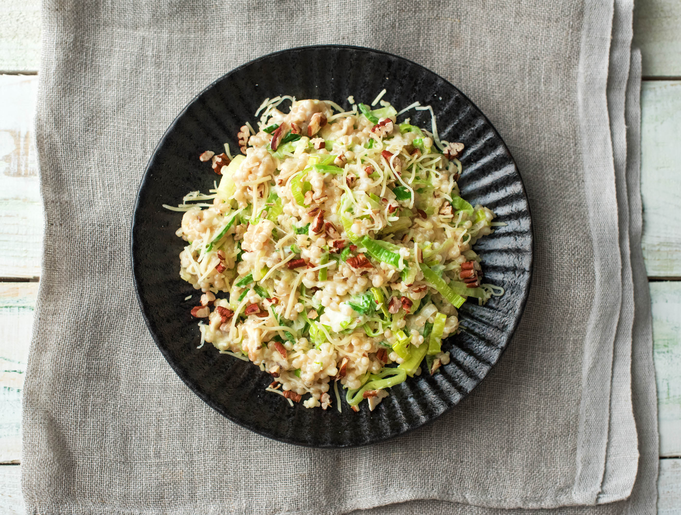 Romige parelcouscous met little gem, oude kaas en pecannoten