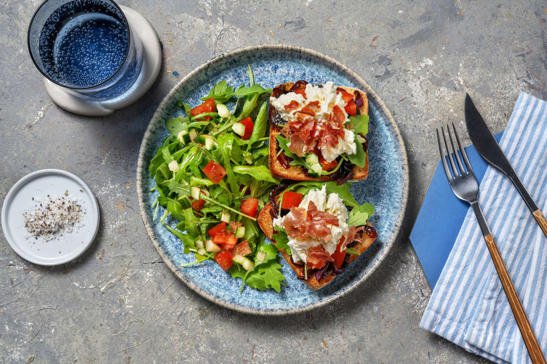 Loaded toasts with a rocket and tomato salad