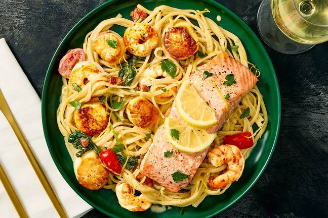 Salmon “en Papillote” over Seafood Linguine