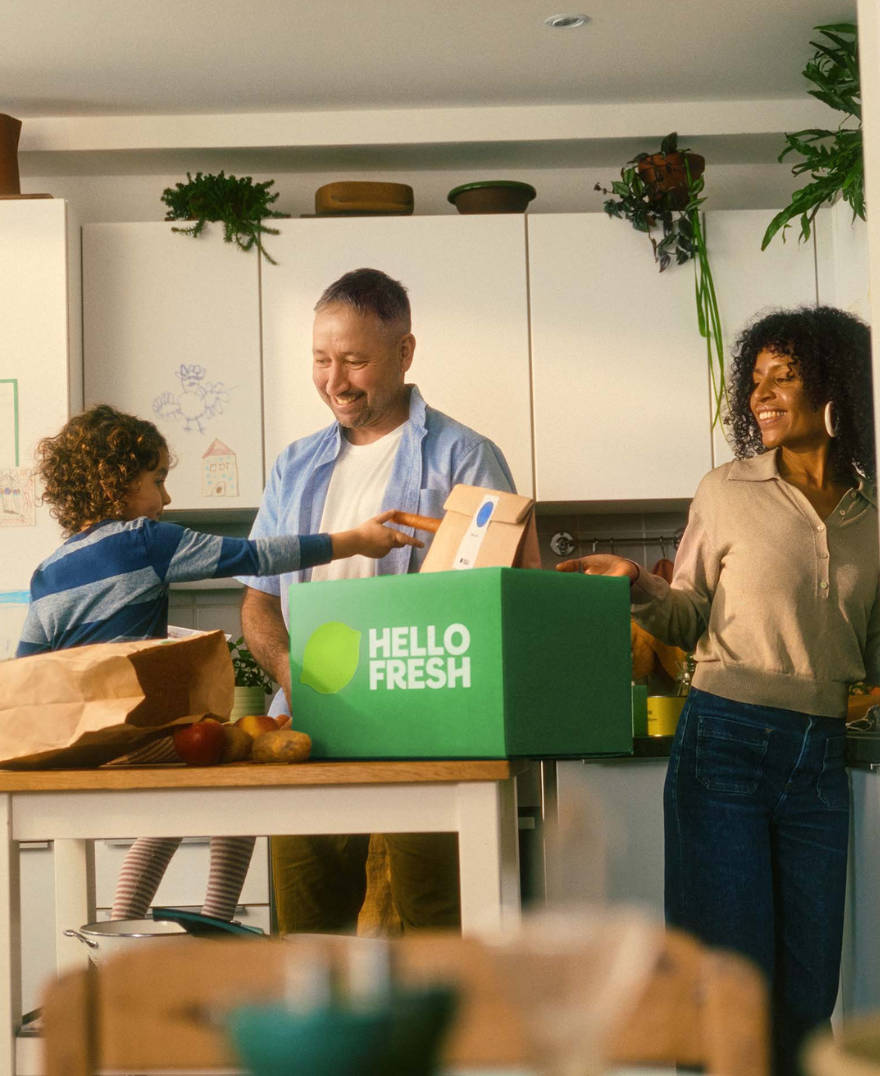 Image of family cooking and enjoying dinner