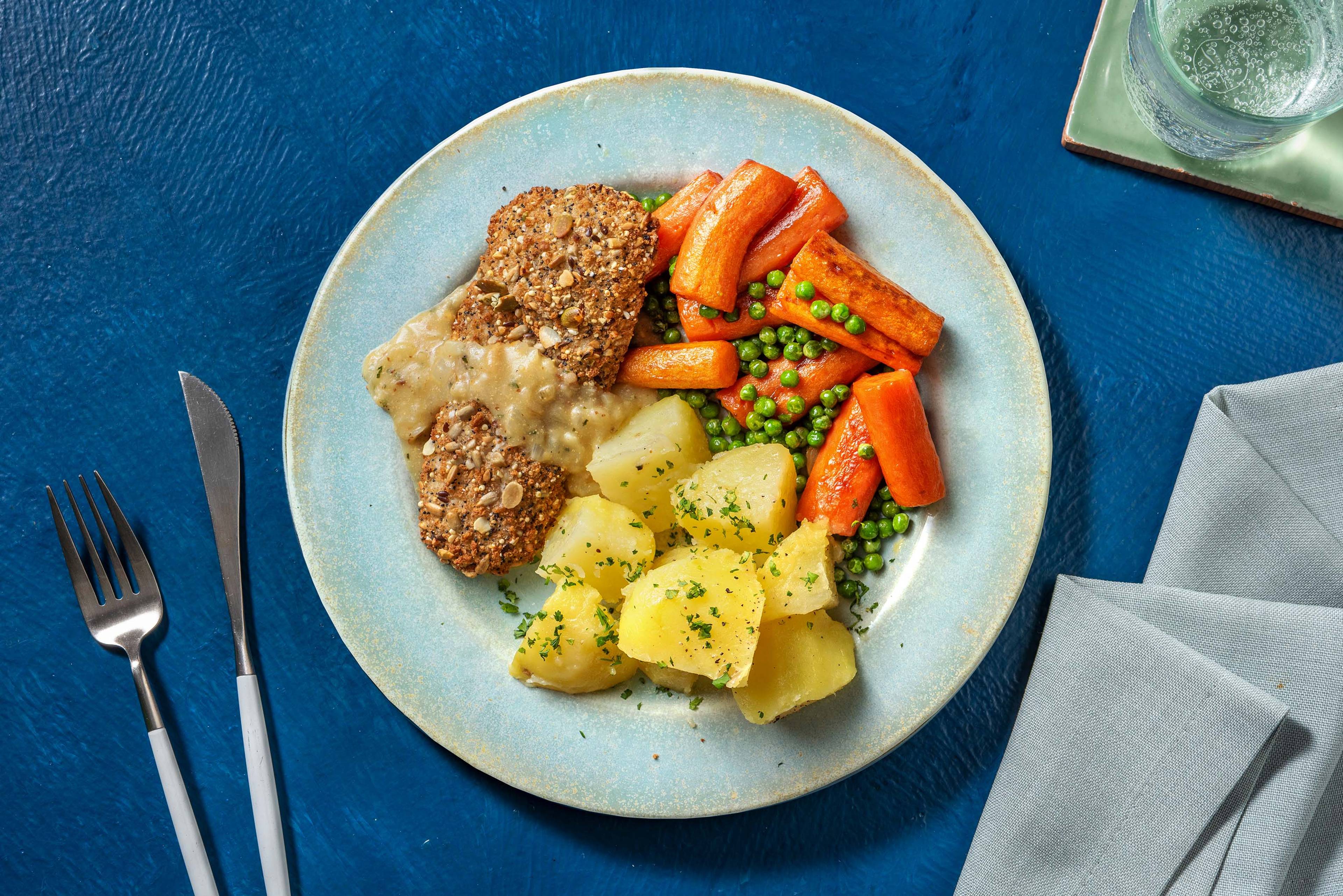 Meerzadenvisschnitzel met doperwten en worteltjes