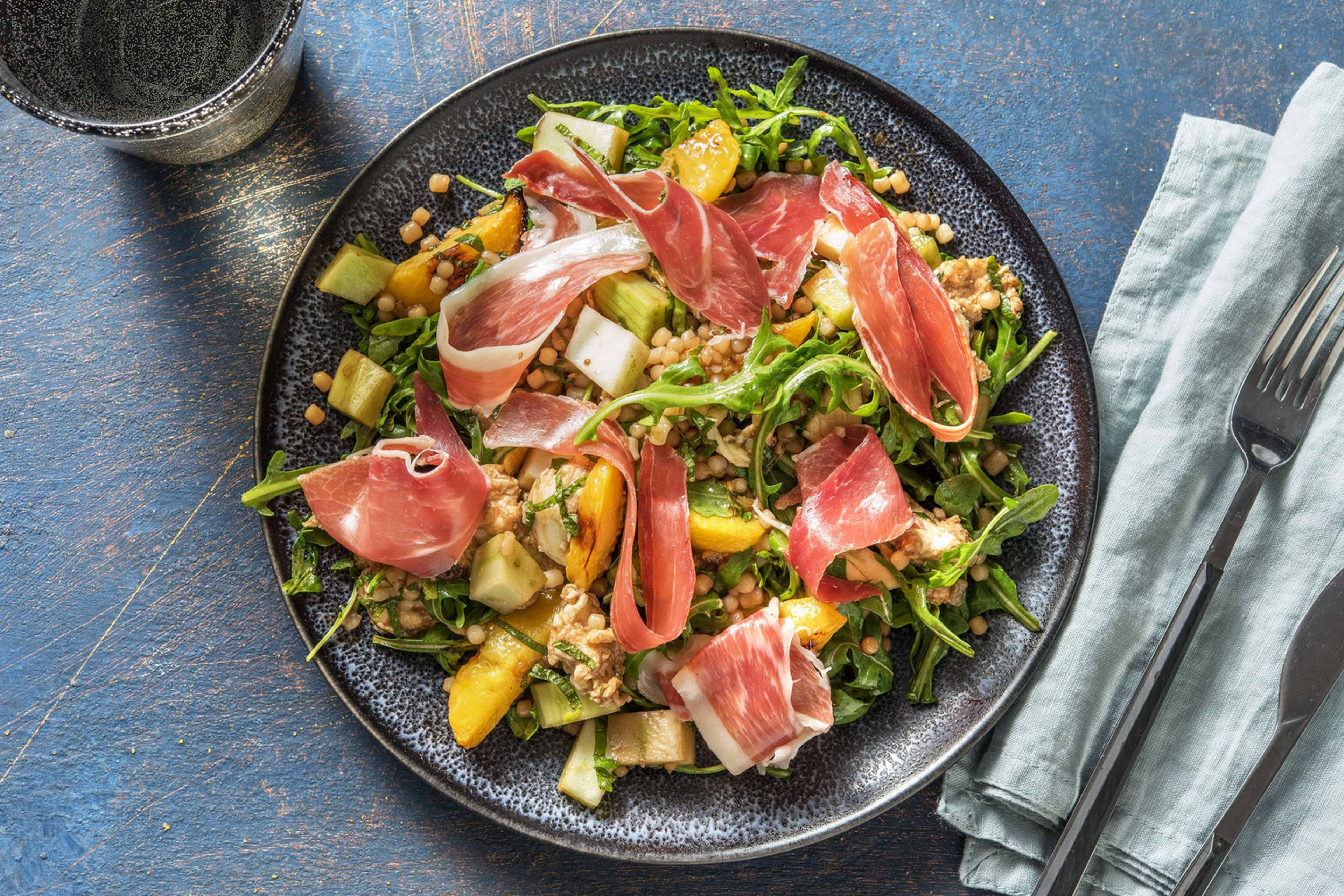 Salade met geroosterde perzik en serranoham