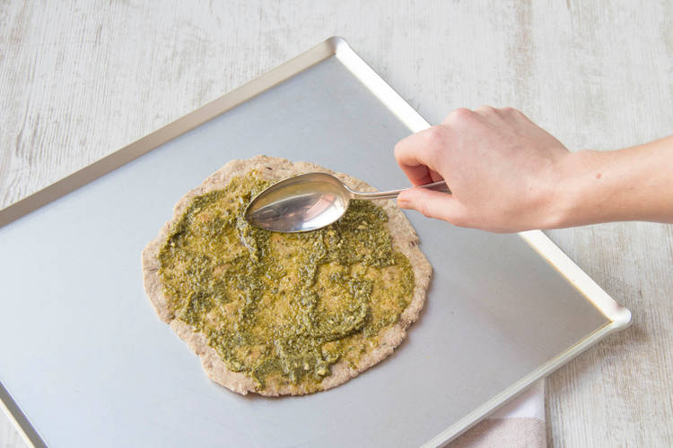 Spread the pizza base with the pesto