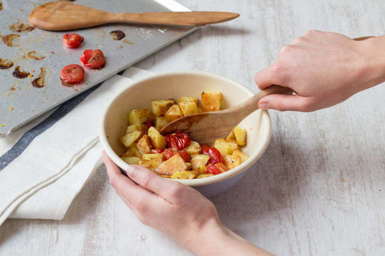 Toss cooked tomatoes and potatoes together