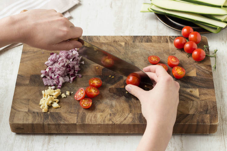 Chop tomatoes in half