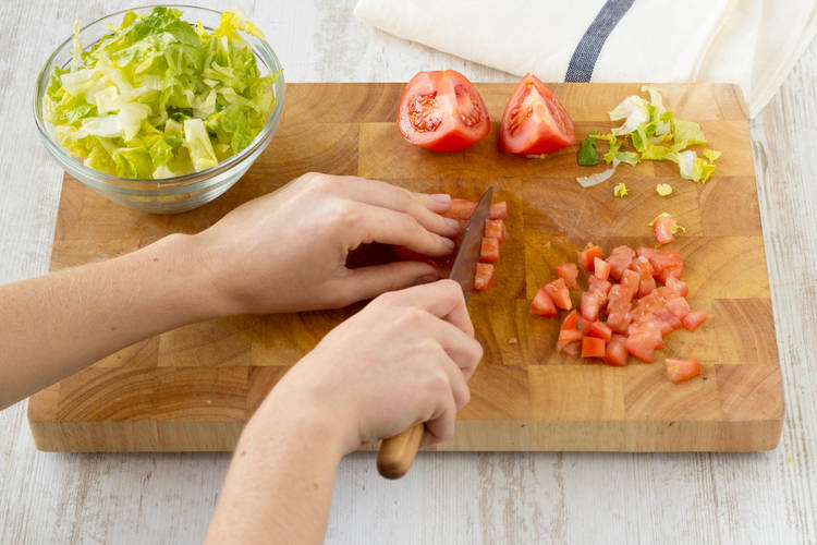 Remove the seeds from the tomato and cut into tiny squares