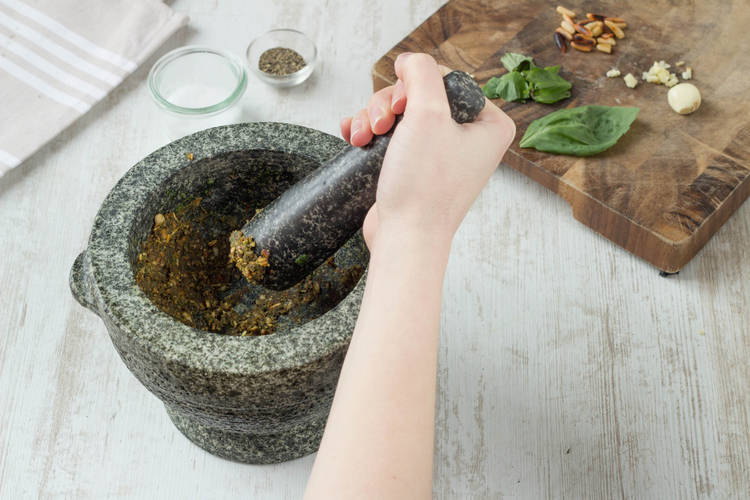 Grind the basil and garlic to a paste