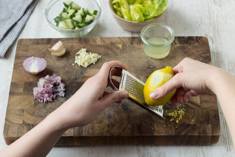 Grate a pinch of lemon zest.