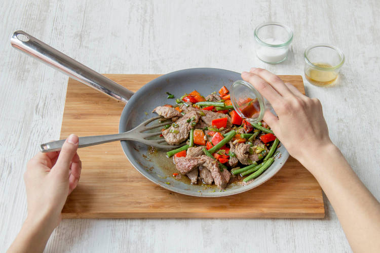 Toss the cooked beef and vegetables with sauce