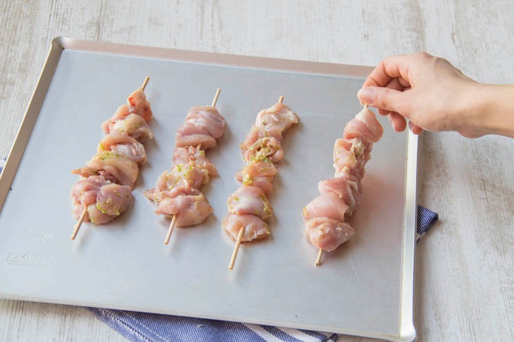Place the chicken skewers on a baking tray
