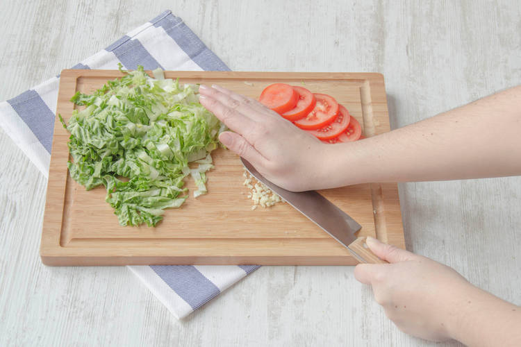 Use the flat side of your knife to mash it