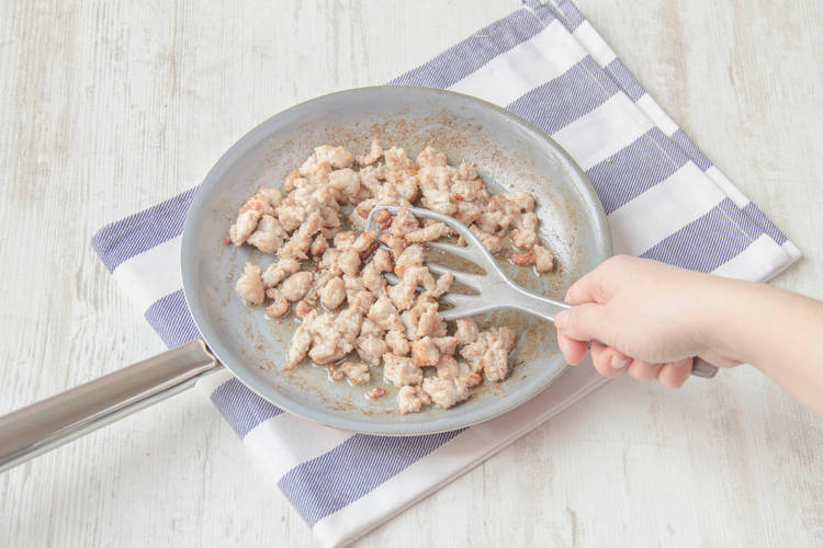 Add the sausage meat and break it up with a spoon