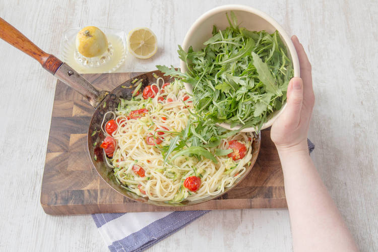 Mix linguine with vegetables and rocket