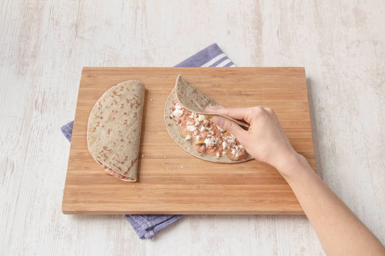 Fold over the other side of the tortilla to make half moon shaped quesadillas.