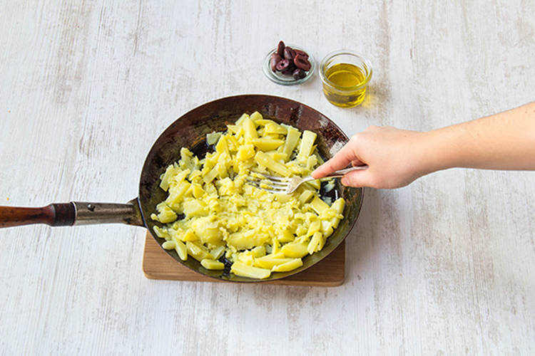 Mash potatoes with oil and olives