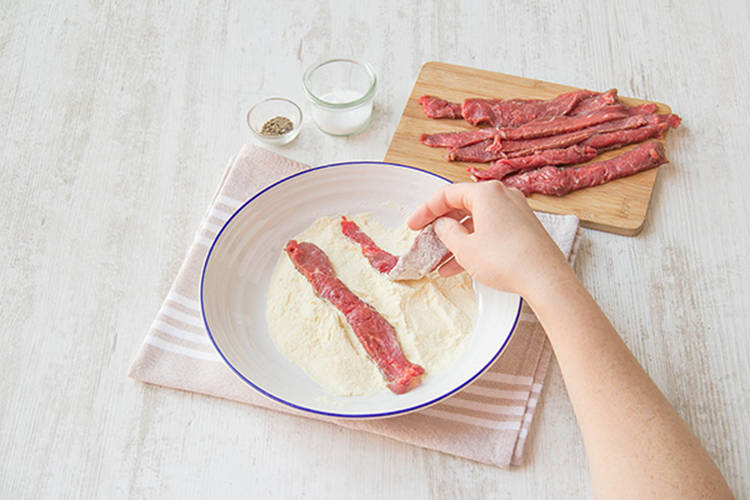 Coat the beef in the cornflour