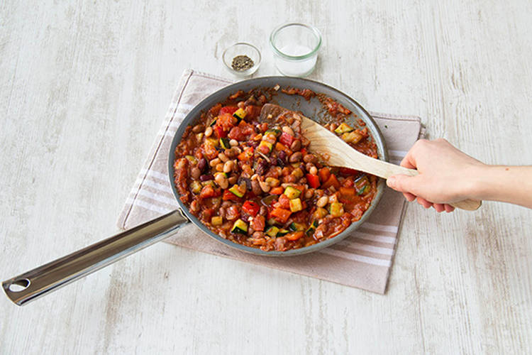 Add the chopped tomatoes, the herbs and the mixed beans