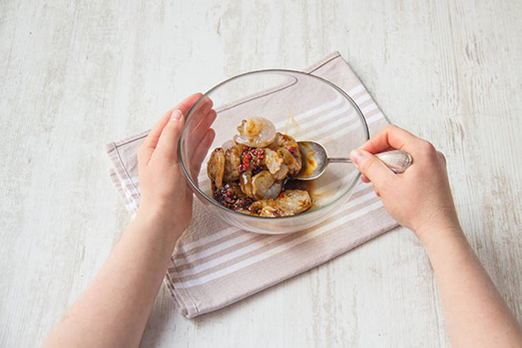 Toss the prawns with garlic, chilli, ginger and oyster sauce