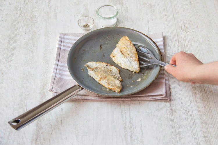 Cook the fish skin side down and season the flesh side with salt and pepper