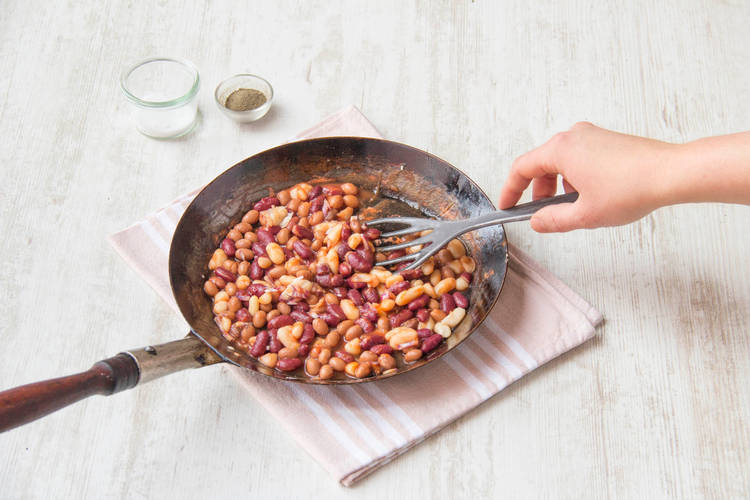 Cook the beans with the tomato purée