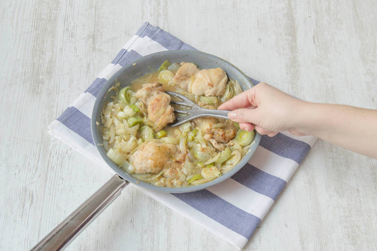 Return the chicken along with the chopped leek, the stock pots and 500ml of water