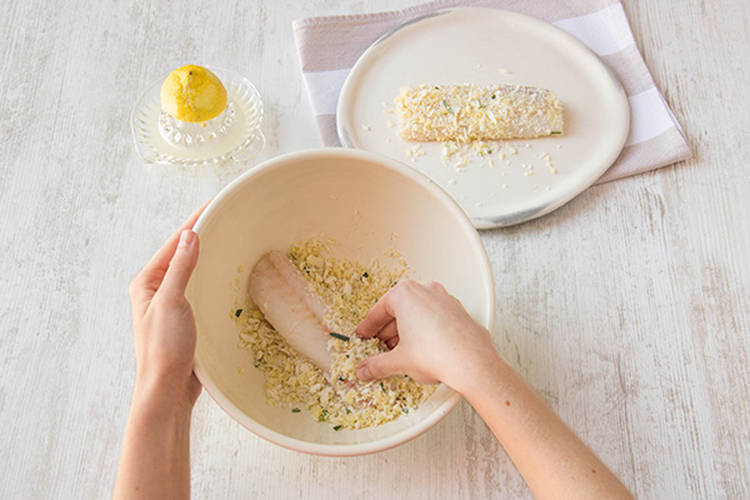 Roll barramundi fillets in crumb mix