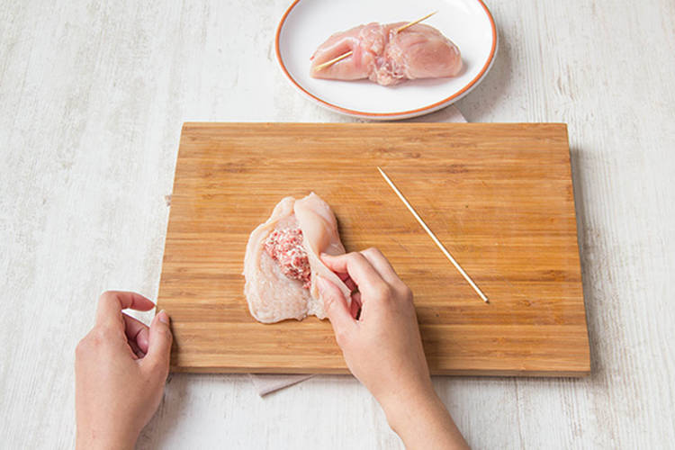 Roll the sausage up in the chicken