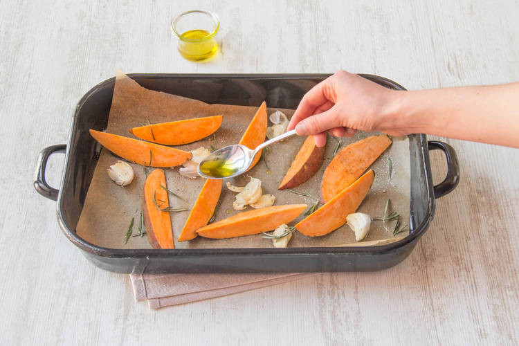 Scatter rosemary over sweet potatoes