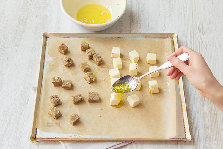Toss rye bread and haloumi with the olive oil