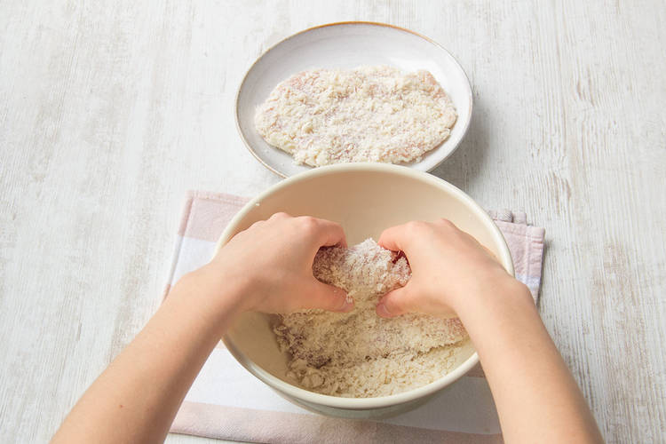 Coat chicken breast in breadcrumbs