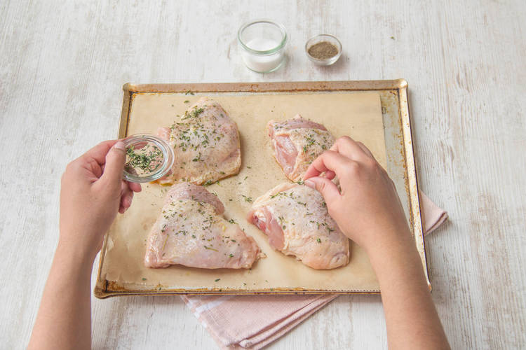 Rub thyme onto chicken
