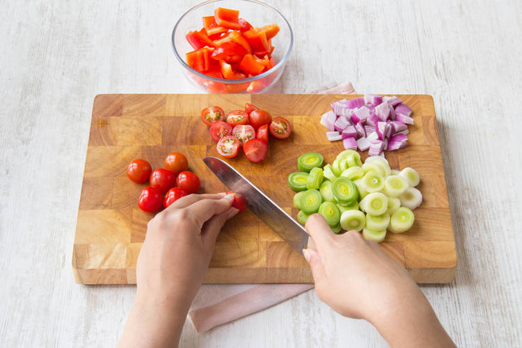 Chop cherry tomatoes in half