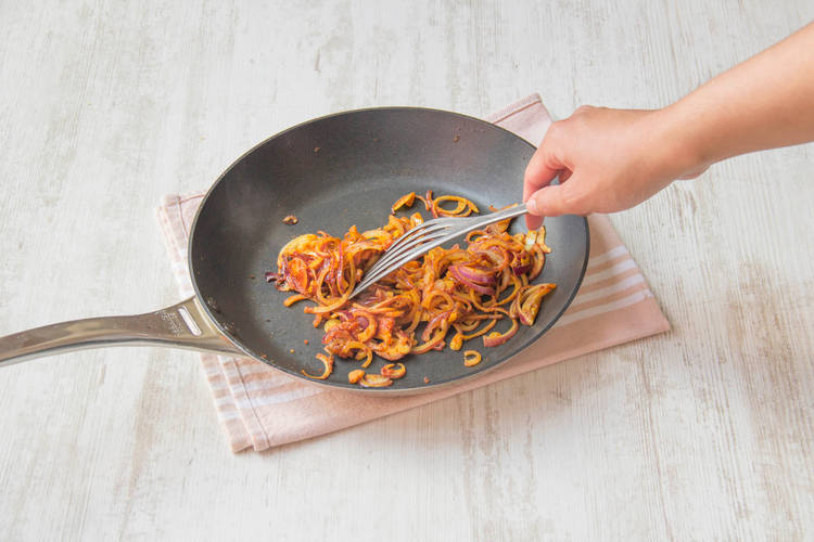 Cook onion with spices