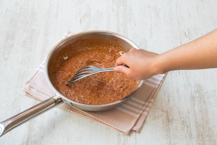 Add bang spice, tomato puree, water and yoghurt to pan