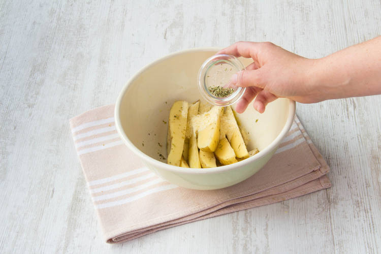 Add oregano to potatoes