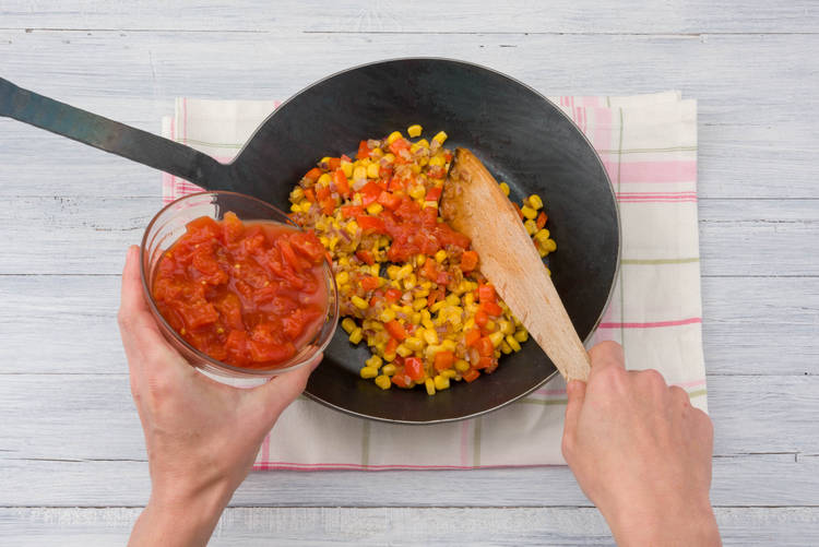 Add the tinned tomato to the pan