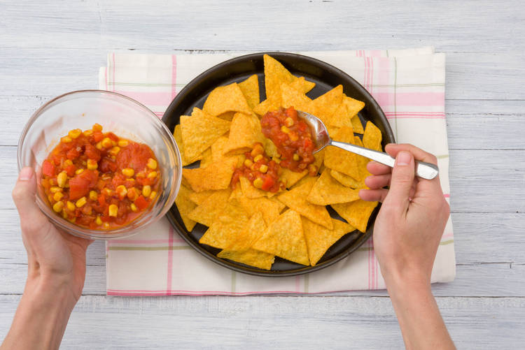 Layer tomato on nachos