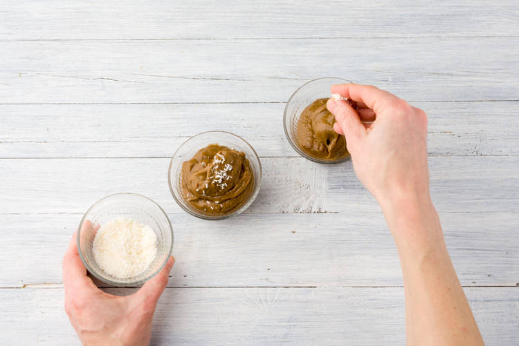 Garneer de chocolademousse met de kokosrasp.