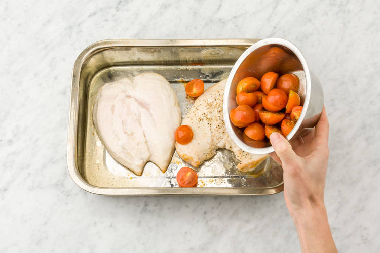 Add the tomatoes to the baking tray