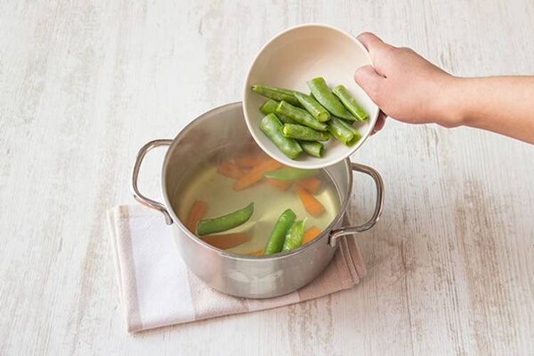 Cook the carrots and snap peas