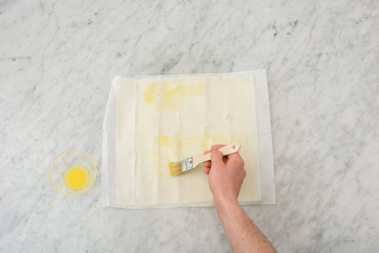 Brush the pastry with butter